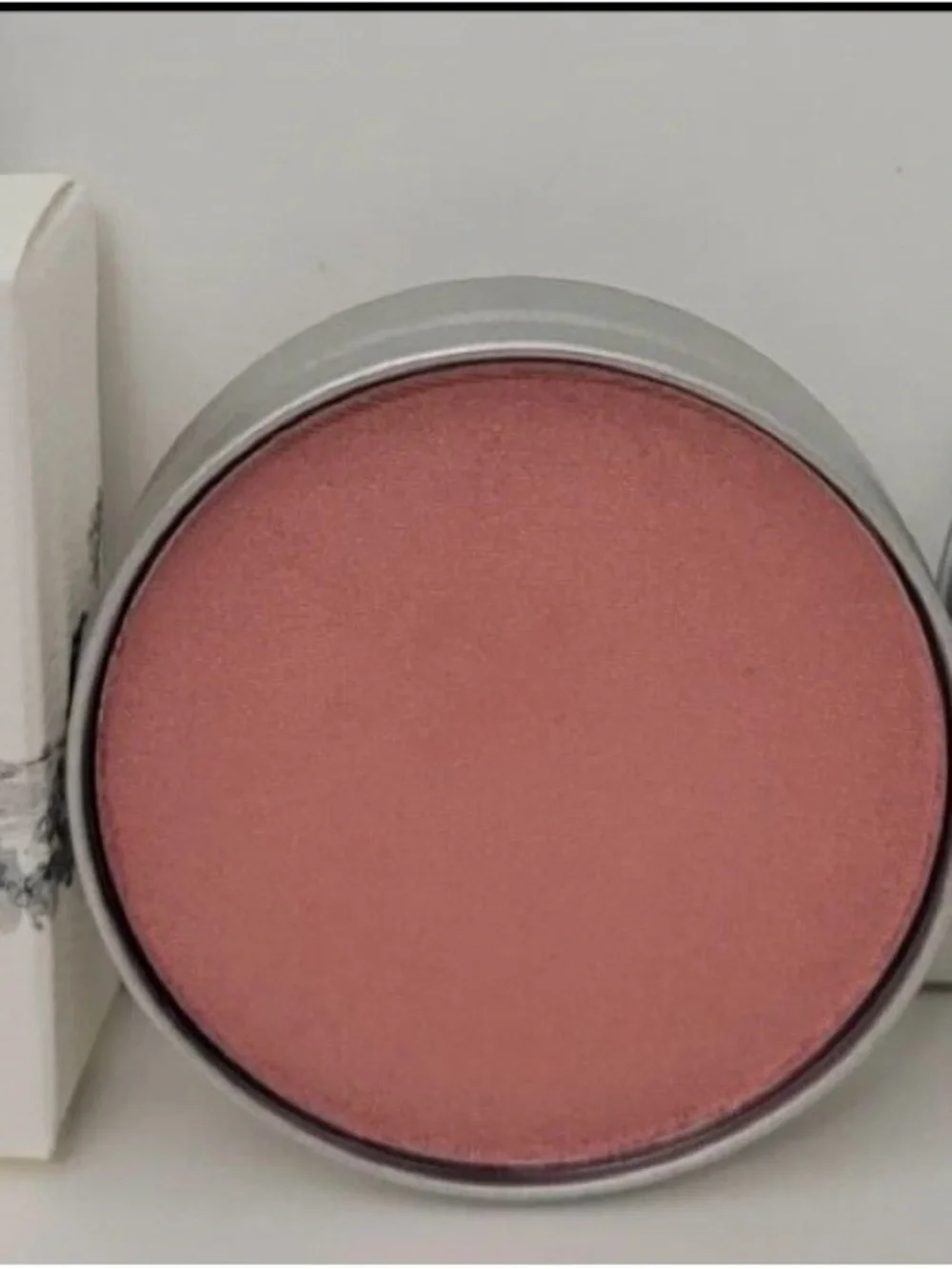 Cargo Cosmetics Powder Blush in Rome (peachy coral in color).